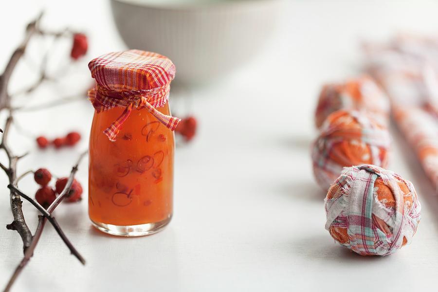 A Jar Of Homemade Rosehip Chilli And Colourful Fabric Baubles Photograph by Schindler, Martina