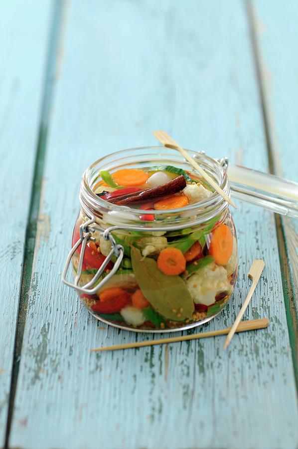 A Jar Of Pickled Vegetables With Cinnamon And Bay Leaves Photograph by Anthony Lanneretonne