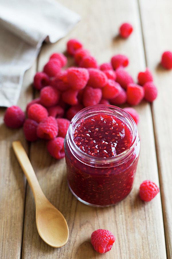 A Jar Of Raspberry Jam And Fresh Raspberries Photograph by Joana Leito
