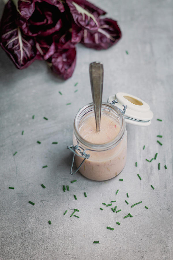 A Jar Of Salad Dressing With Radicchio In The Background Photograph by Tina Engel
