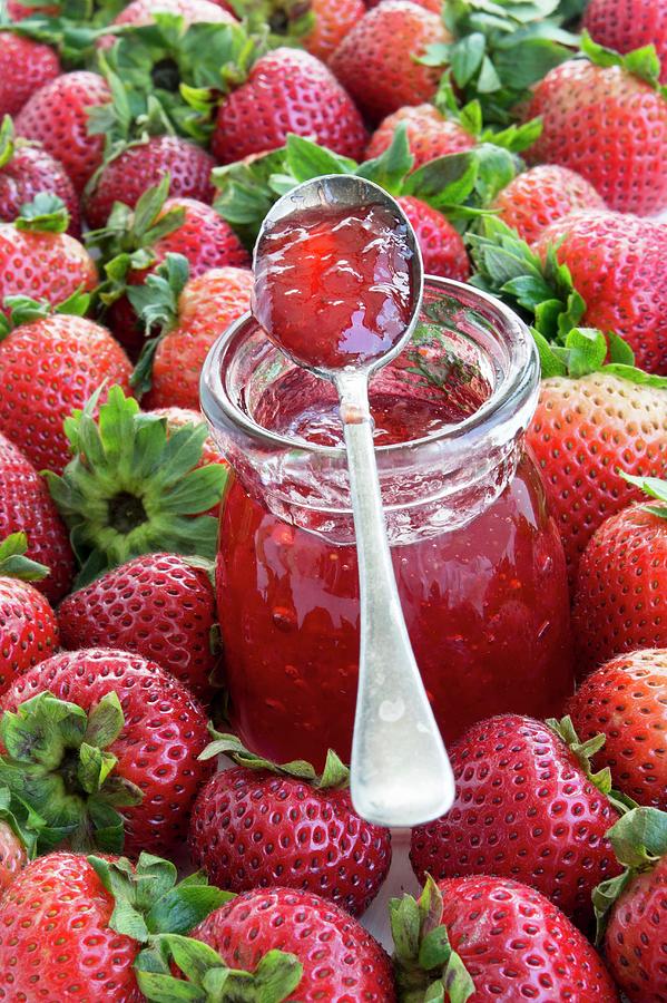 A Jar Of Strawberry Jam Surrounded By Fresh Strawberries Photograph by Martina Schindler