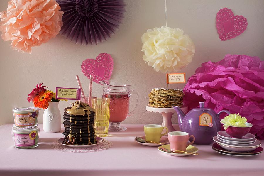 A Jolly Buffet Decorated With Paper Flowers And Various Sweet Dishes Photograph by Great Stock!