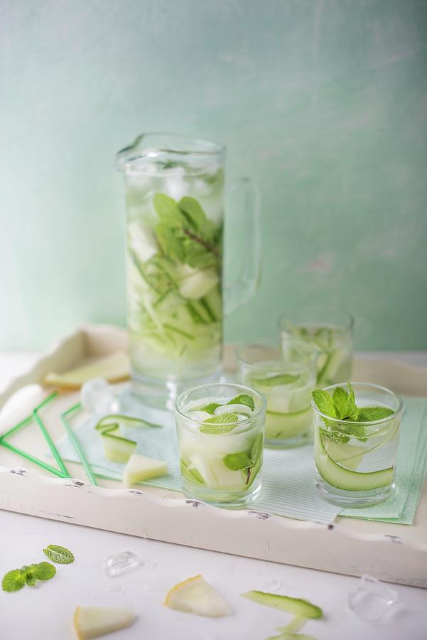 A Jug And Glasses Of Refreshing Cucumber And Melon Water With Fresh Mint For Summer. Photograph by Magdalena Hendey