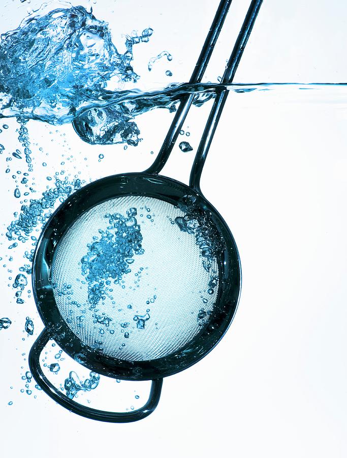 A Kitchen Sieve In Water Photograph by Feig & Feig