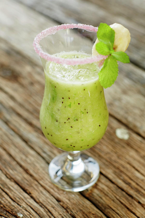 A Kiwi Smoothie In A Glass With A Sugared Rim Photograph by Niklas Thiemann