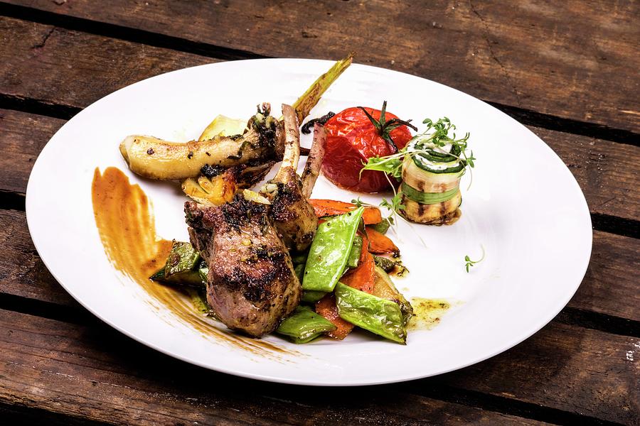 A Lamb Chop Served With Mediterranean Vegetables Photograph by Chris Schfer