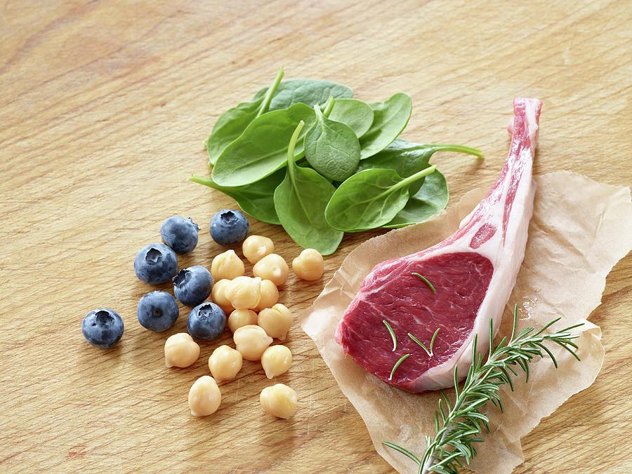 A Lamb Chop With Blueberries, Chickpeas, Rosemary And Spinach Photograph by Leigh Beisch