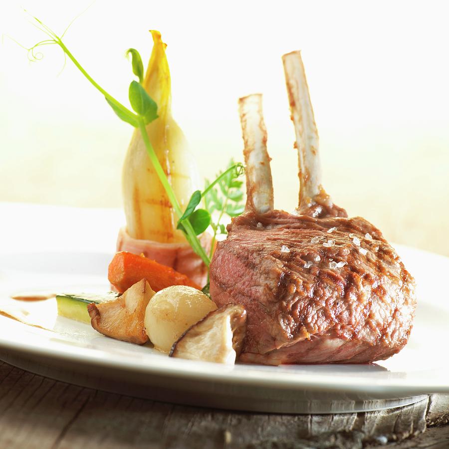 A Lamb Chop With Herb Butter And Grilled Chicory Photograph by Frank Croes
