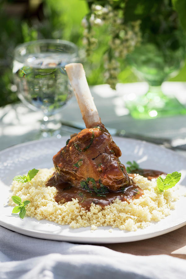 A Lamb Shank With Couscous On A Summery Table Outdoors Photograph by Winfried Heinze