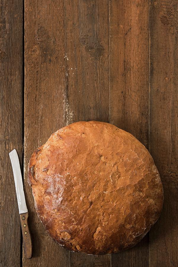 A Large Round Loaf Of Wheat And Rye Bread Photograph by Edyta Girgiel