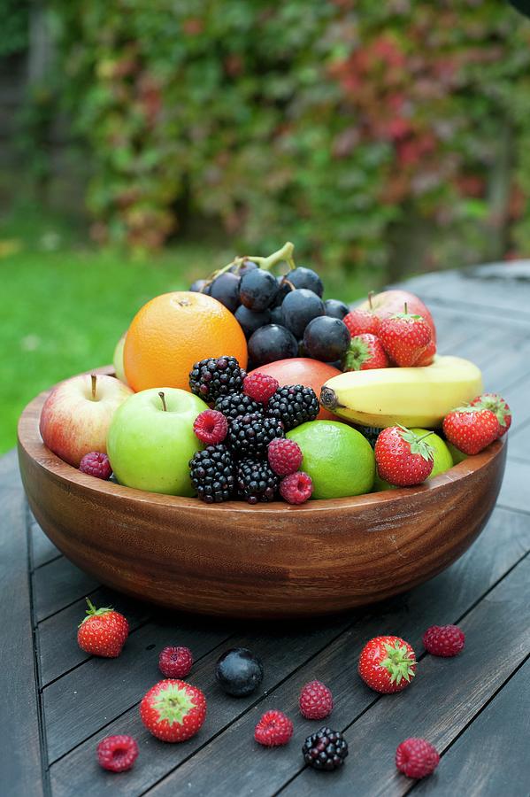 A Large Wooden Bowl Filled With Fresh Fruit And Berries Photograph by Sarka Babicka