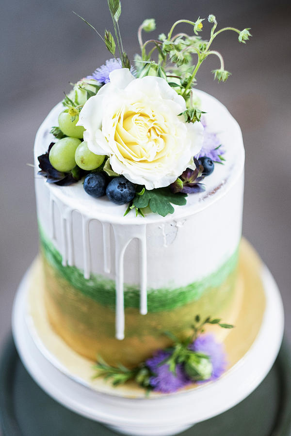 A Layered Cake With Gold, Green, Grapes And Flowers Photograph by Lucie Beck
