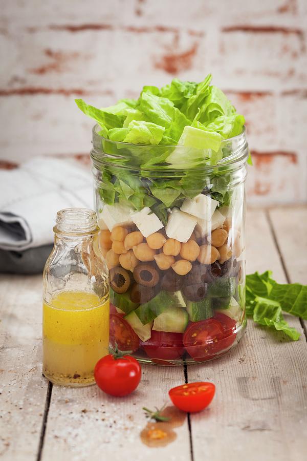 A Layered Chickpea Salad In A Jar Photograph by Eising Studio - Food Photo & Video