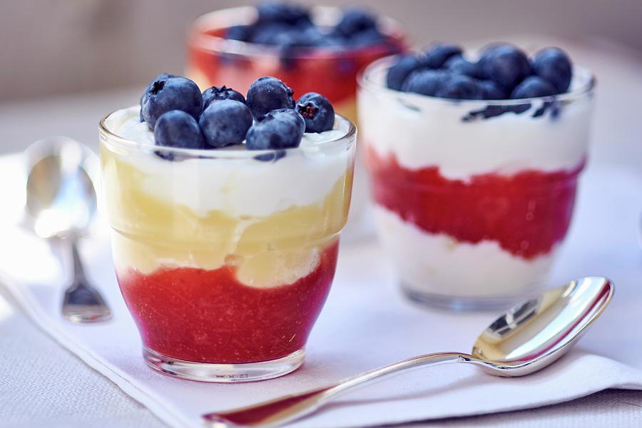 A Layered Dessert Made Of Strawberry Sauce, Vanilla Cream And Blueberries Photograph by Bernhard Winkelmann