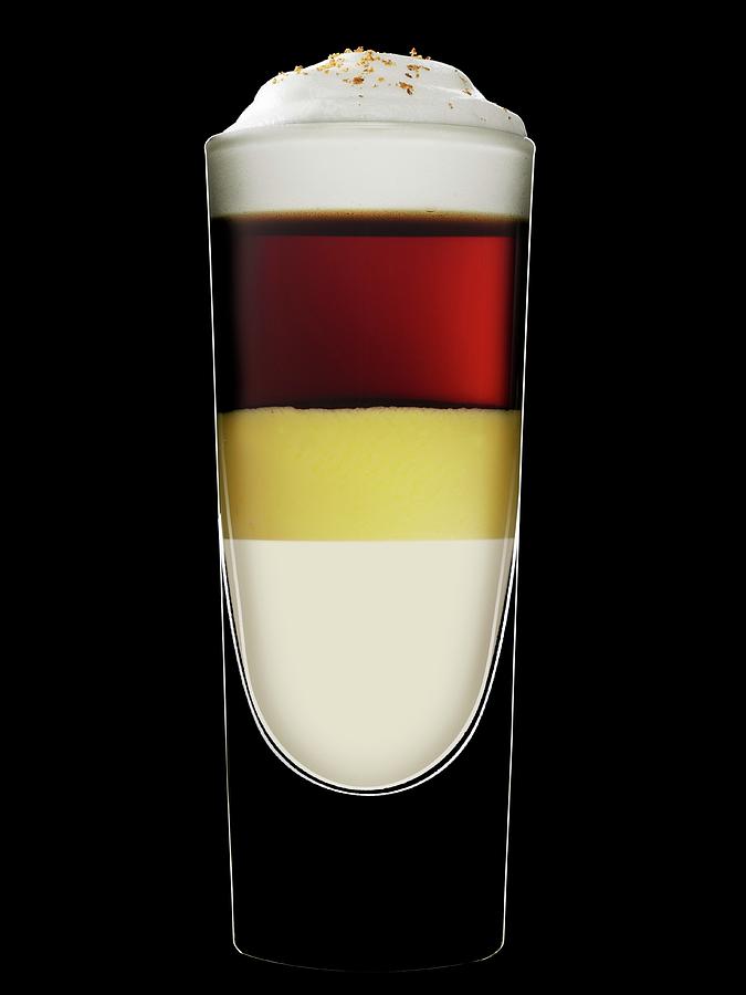 A Layered Drink With Eggnog Against A Black Background Photograph by Hermann Drre
