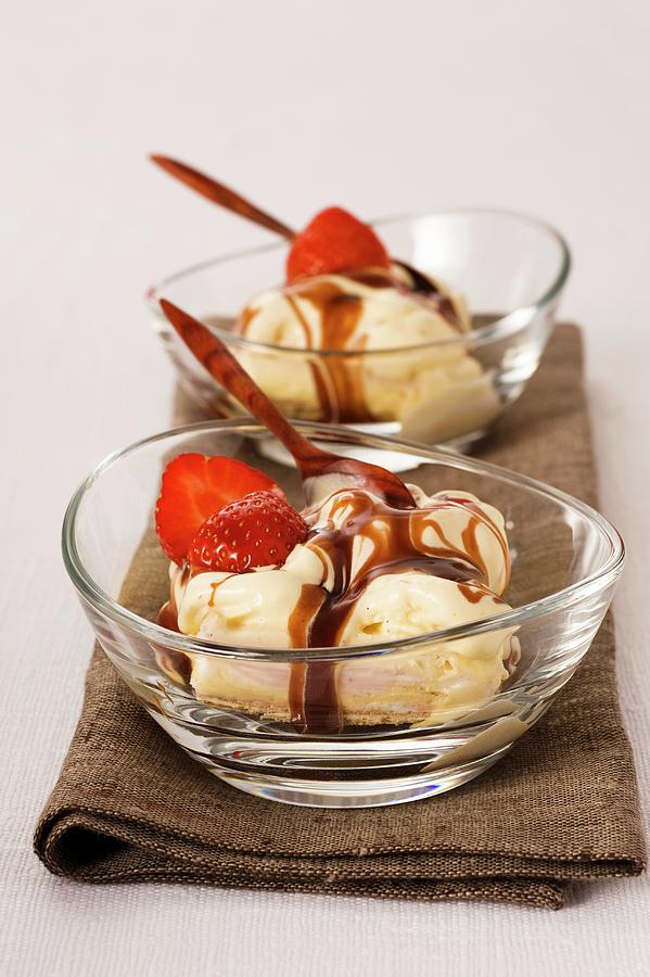 A Layered Ice Cream Dessert With Strawberries And Caramel Sauce Photograph by Gerlach, Hans