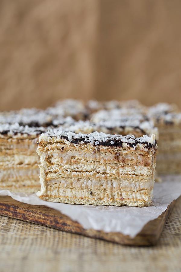 A Layered Sponge Cake With Walnut And Coconut Cream Glazed With Ganache Photograph by Malgorzata Laniak