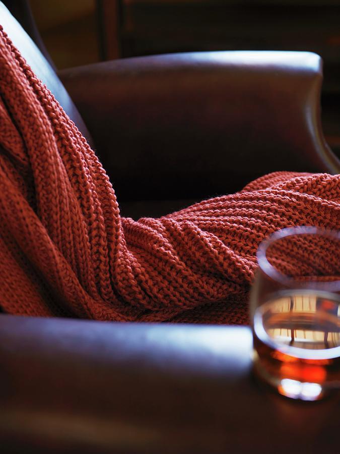 A Leather Arm Chair With A Cable Knit Throw And Glass Of Bourbon Photograph by Bronze Photography
