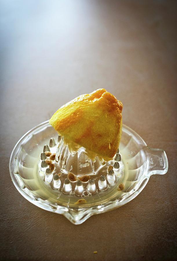 A Lemon Half On A Juicer Photograph by Roger Stowell
