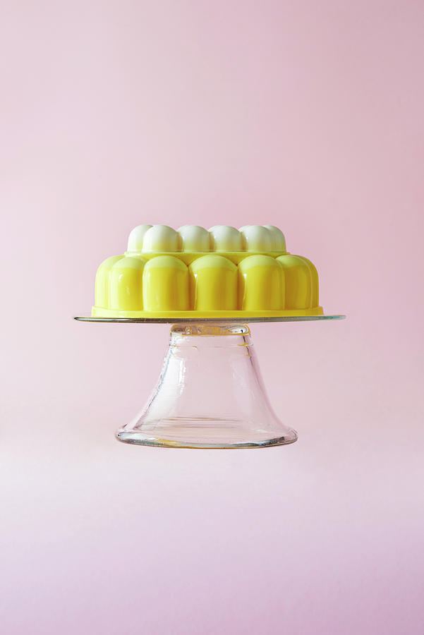 A Lemon Merringue Jelly On A Cake Stand On A Pink Background Photograph by Michael Hart