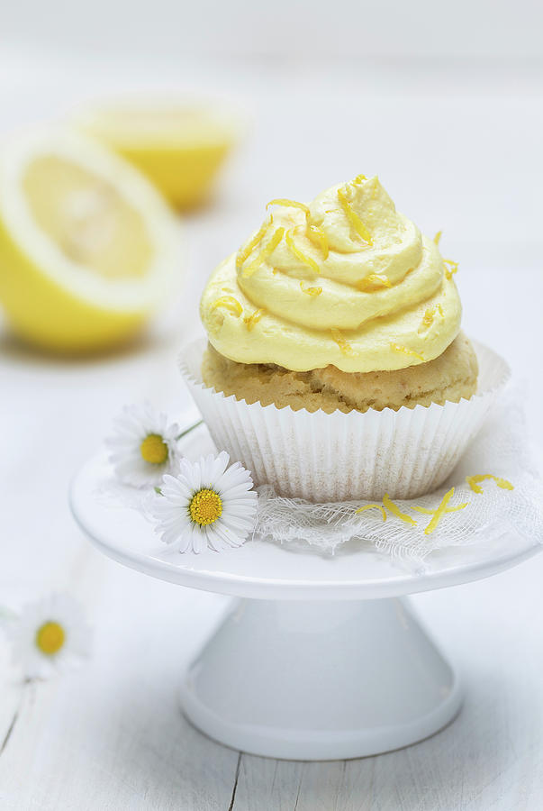 A Lemon Muffins With Frosting On A Mini Cake Stand Photograph by Nils Melzer