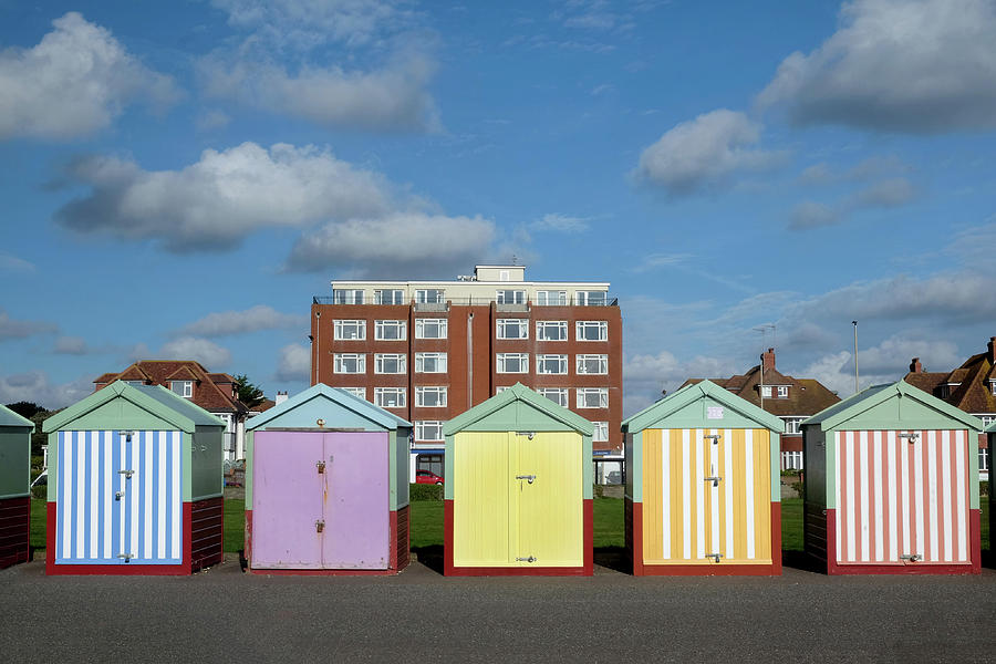 a line of five beach huts on Brighton promenade 5 beach huts are