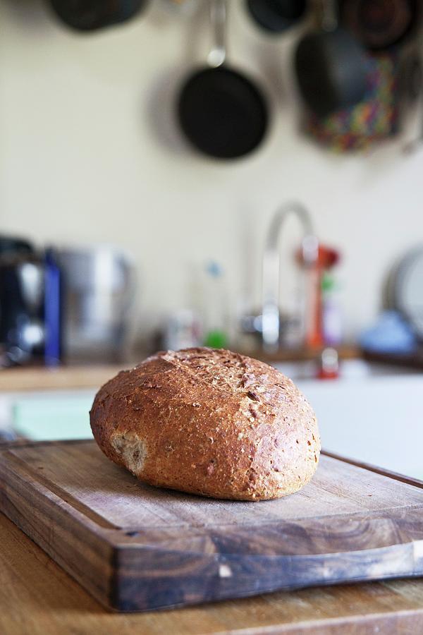 A Loaf Of Country Bread In A Kitchen Photograph by George Blomfield