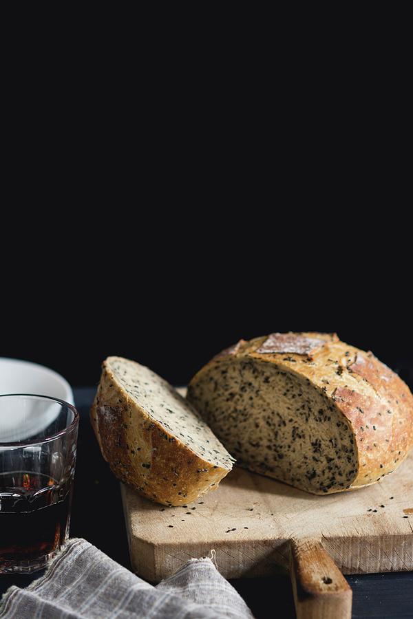 A Loaf Of Country Bread On A Chopping Board Next To A Glass Of Beer Photograph by Andie