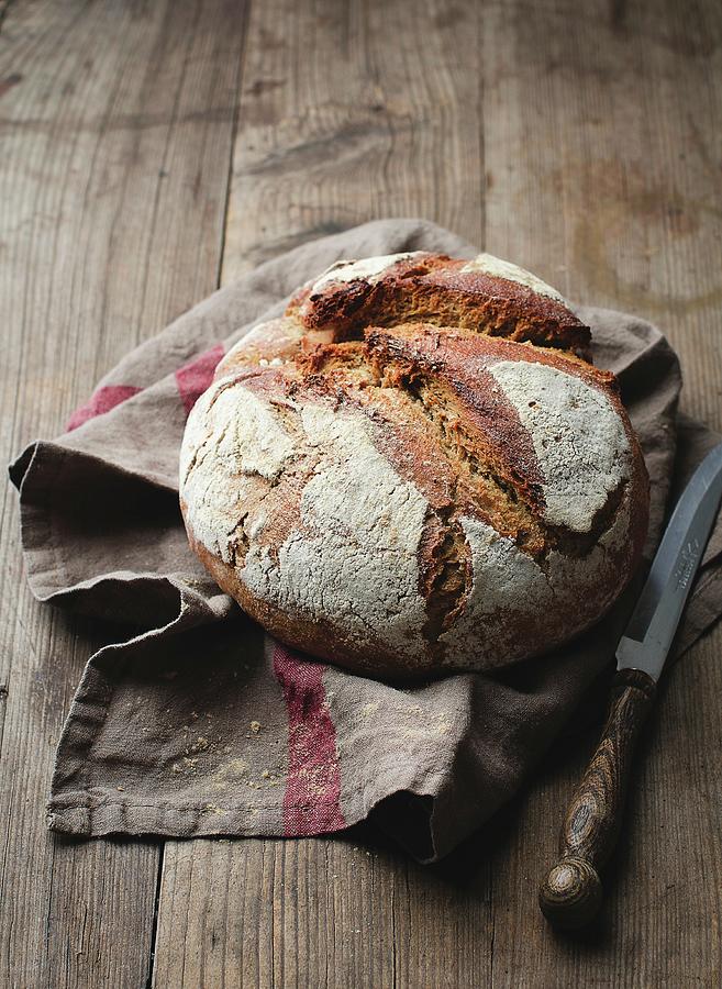 A Loaf Of Rye Bread On A Dish Towel Photograph by Ewgenija Schall