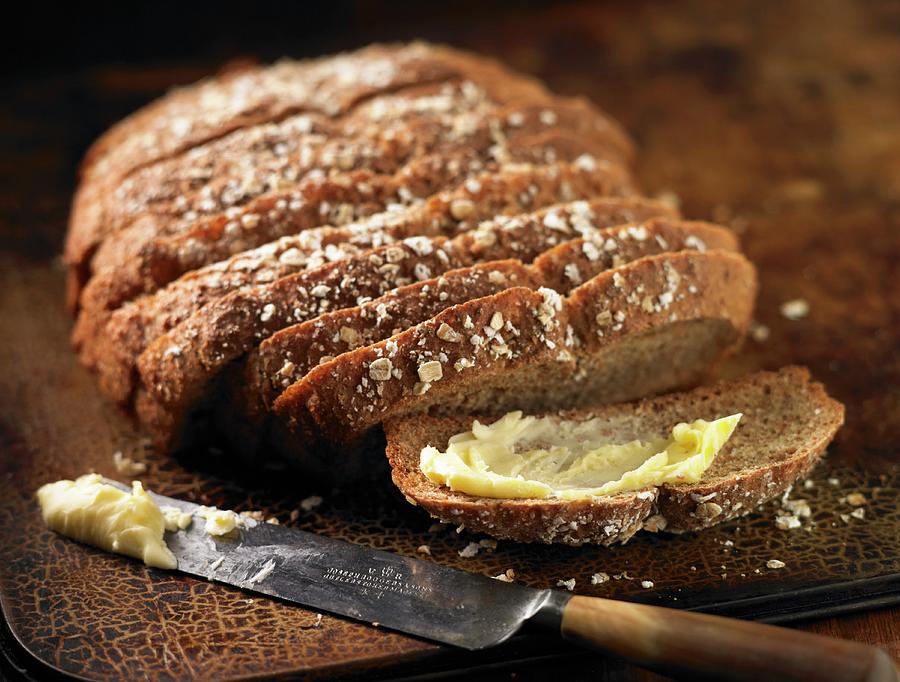 A Loaf Of Soda Bread, Sliced, With One Slice Buttered Photograph by Atkinson / Sue Dr.