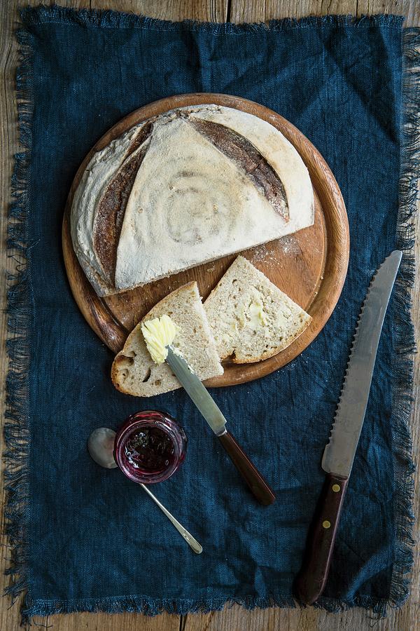 A Loaf Of Sour Dough Bread With Some Slices Spread With Butter And Jam seen From Above Photograph by Magdalena Hendey