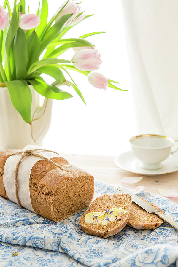 A Loaf Of Spelt Bread With Butter And Herb Salt Photograph by Sandra Krimshandl-tauscher