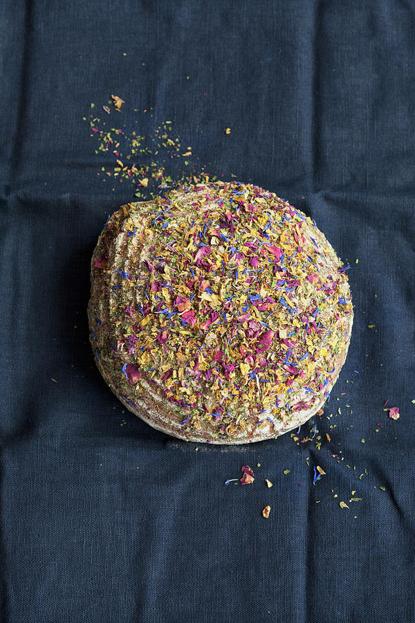 A Loaf Of Wholemeal Bread Topped With Edible Flowers Photograph by Katrin Winner