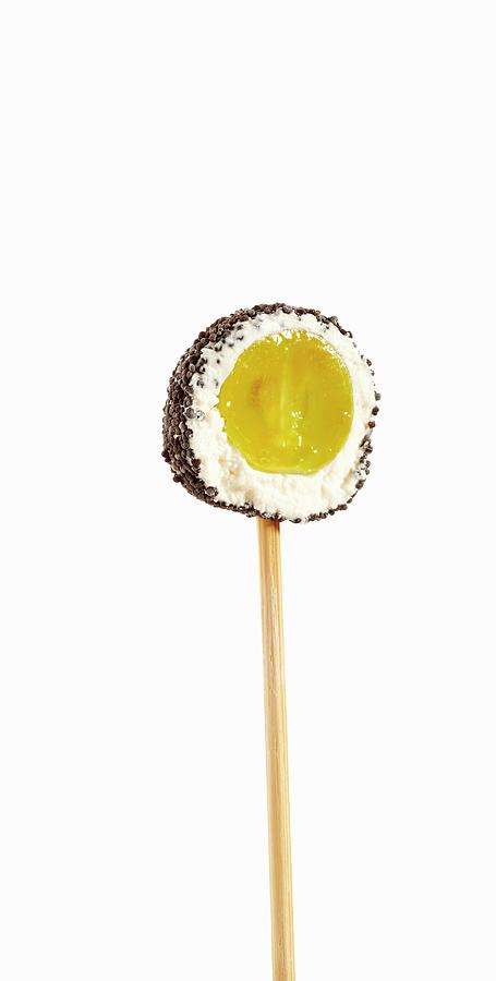 A Lollipop Of A Grape Coated In Cream Cheese And Poppy Seeds Photograph by Atelier Mai 98