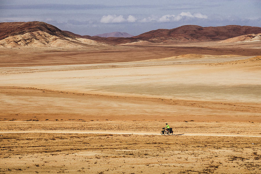 A lonely cyclist in the Atacama Desert, Chile Photograph by Kamran Ali