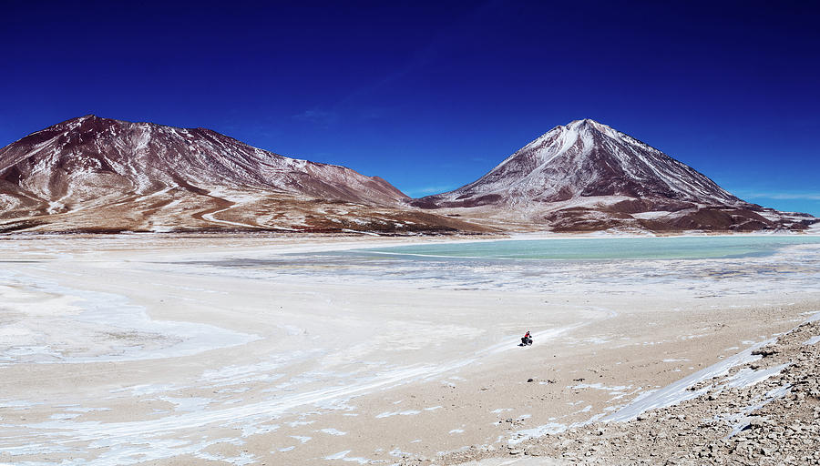 A lonely cyclist in the Bolivian Altiplano Photograph by Kamran Ali