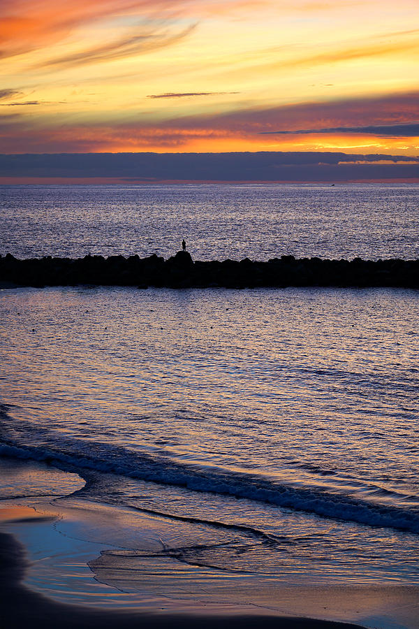 Sunset Photograph - A lonely person at sunset on the island of Tenerife, in Spain. by George Afostovremea