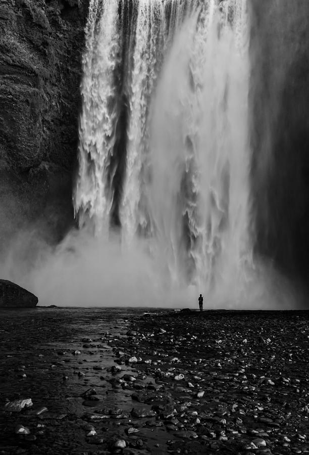 A Lonely Person Standing Next To Skogafoss Waterfall In Iceland In Black And White. Photograph