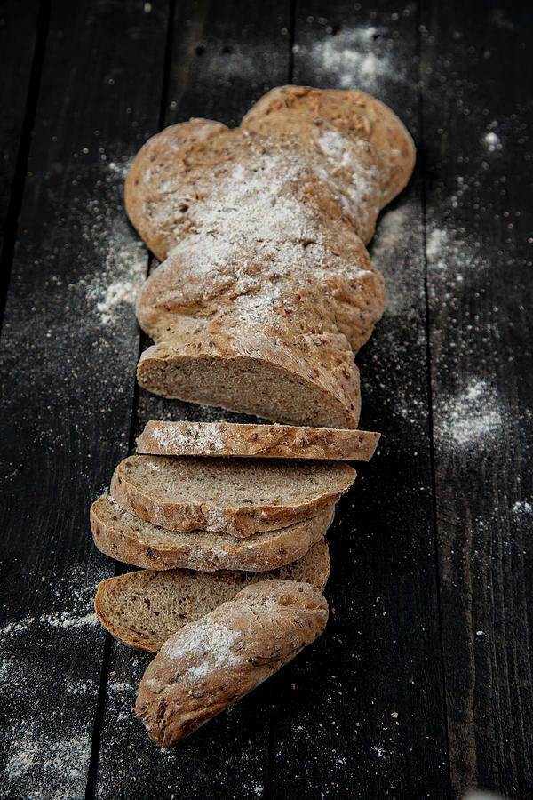 A Long Loaf Of Flax Seed Wholemeal Bread, Sliced Photograph by Julia Skowronek