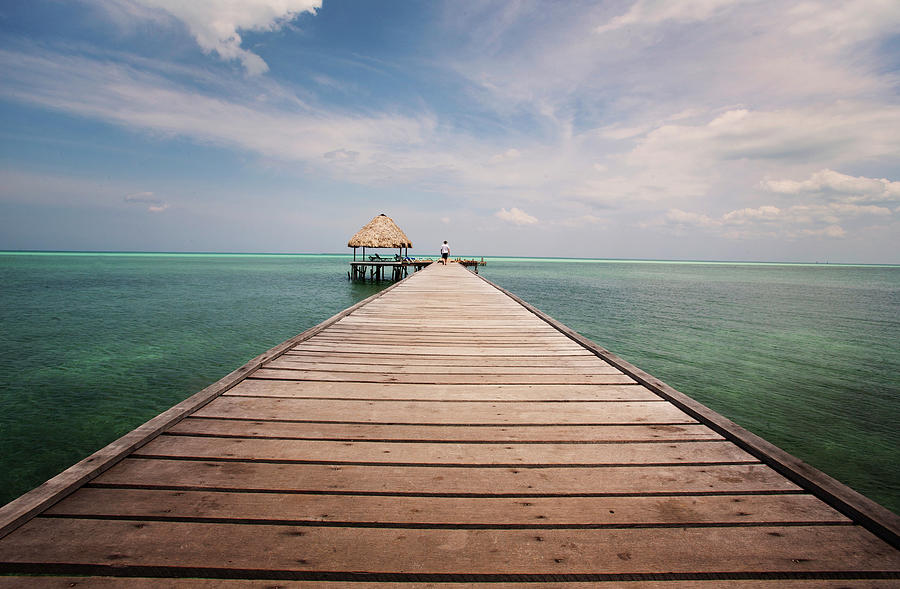 A Long Wooden Ocean Jetty Photograph by Russell Monk