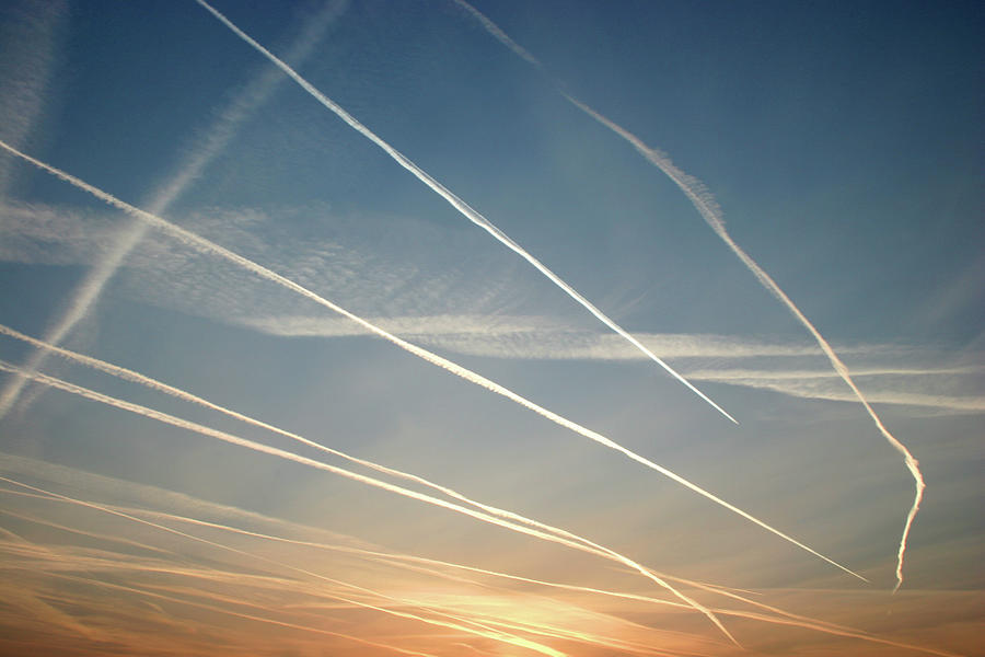 A Lot Of Vapor Trails During Sunset Photograph by Alfsky