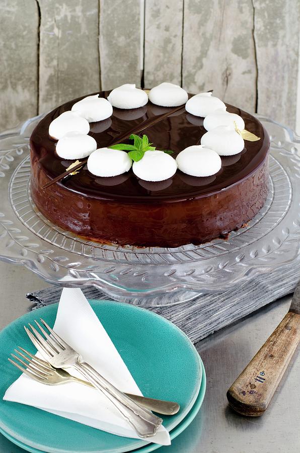 A Luxurious Chocolate Cake With Chocolate Glaze, White Meringues And Mint Photograph by Jamie Watson