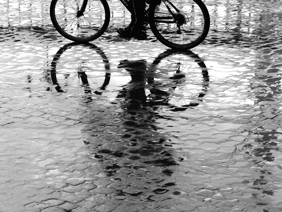 A Man On A Bike After The Rain Photograph by Enzo D.