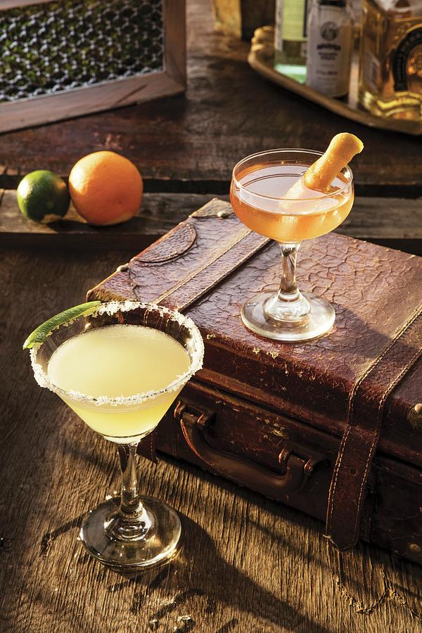 A Margarita Cocktail And A Manhattan Cocktail On An Old Suitcase Photograph by Cindy Haigwood