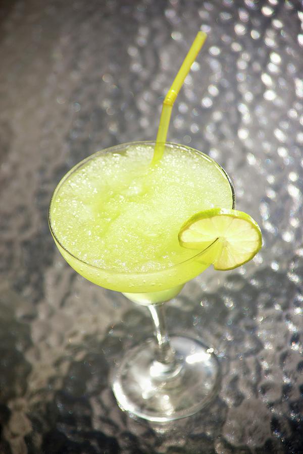 A Margarita With A Lime Slice And A Straw Photograph by William Boch