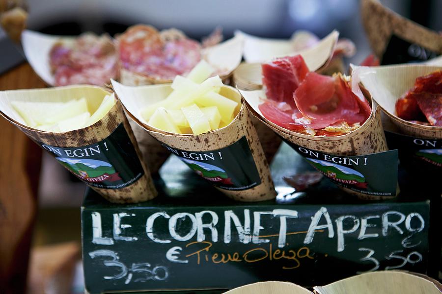 A Market Stall With Cheese, Ham And Sliced Sausage In Paper Cones Photograph by Moe Kafer Photography