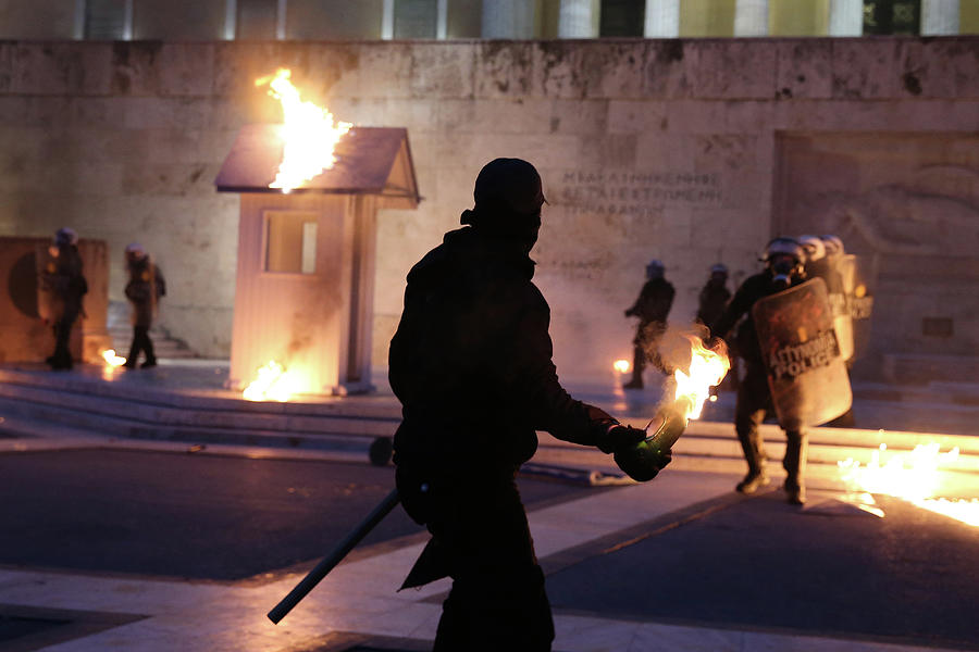 A Masked Demonstrator Prepares to Throw Photograph by Costas Baltas ...