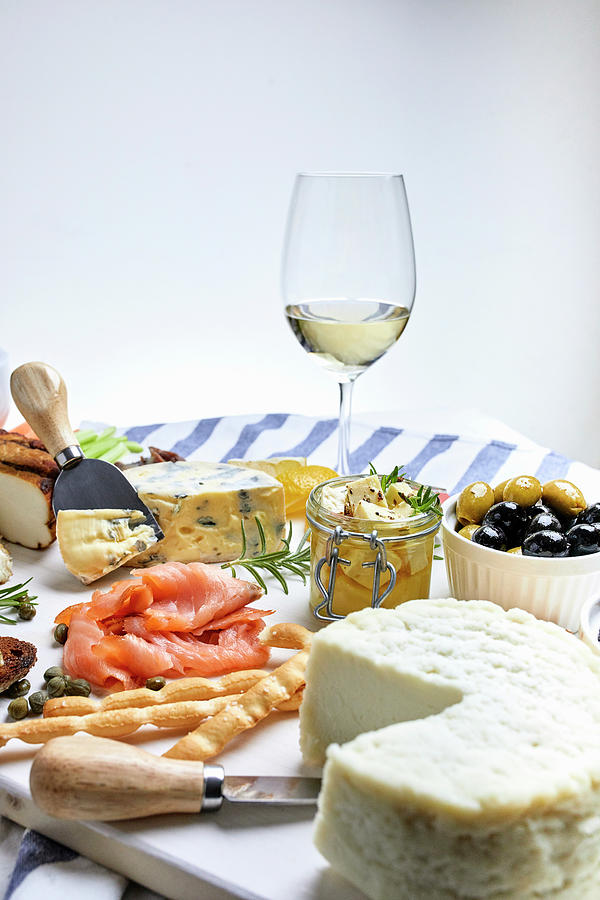 A Mediterranean Appetizer Platter With Cheese, Fish, Olives And White Wine Photograph by Natasa Dangubic