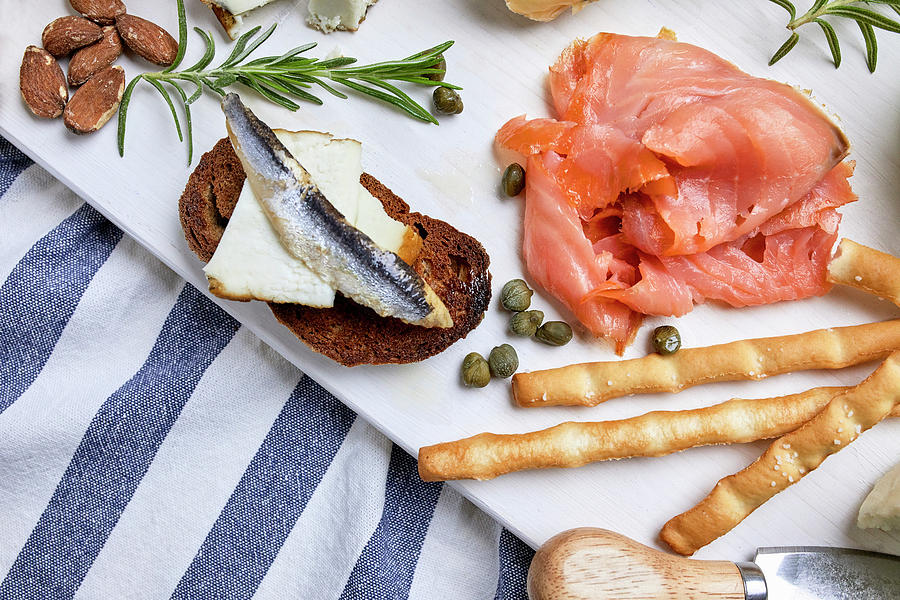 A Mediterranean Appetizer Platter With Salmon, Grilled Bread And Bread Sticks Photograph by Natasa Dangubic