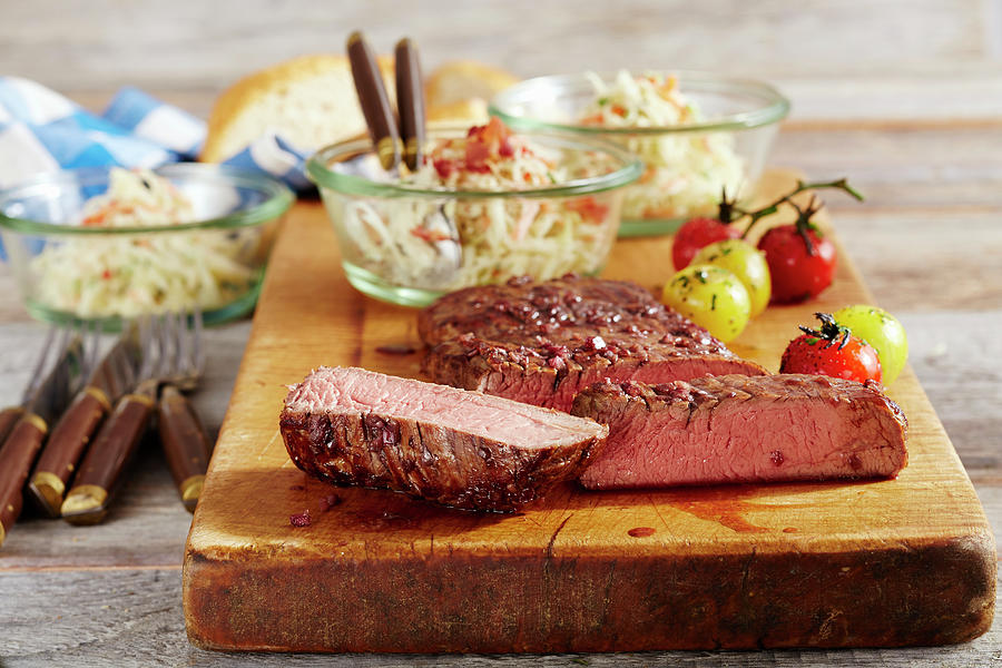 A Medium Grilled Flank Steak With Coleslaw And Cherry Tomatoes On A Wooden Board Photograph by Teubner Foodfoto